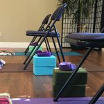 yoga room with blocks, blankets, chairs, mats